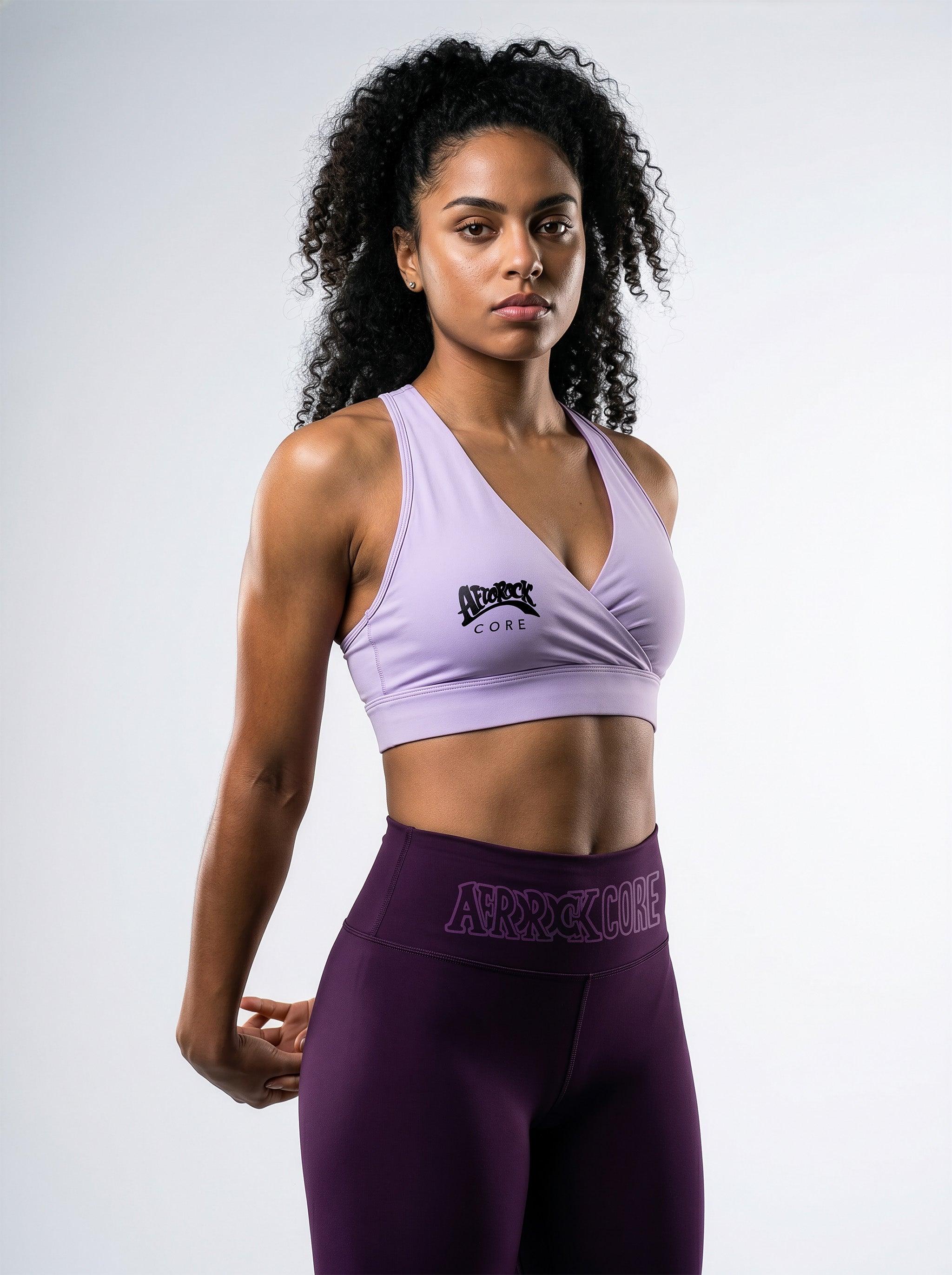 Model Kayla wearing the AfroRock Core high-waisted Purple yoga leggings and Purple sports bra. Premium streetwear-inspire Purple activewear designed for performance and style.⁠