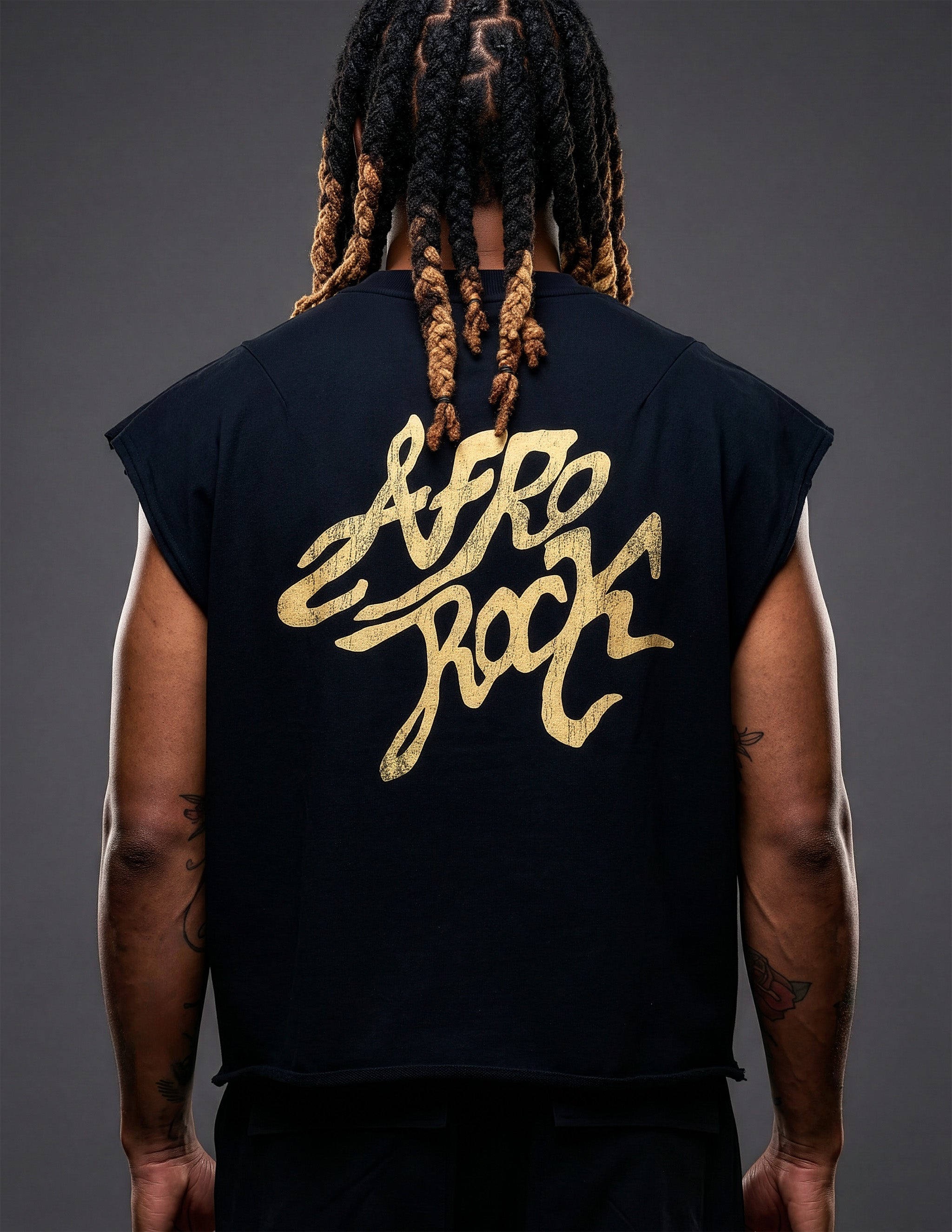 Back view of Kal AfroRock wearing the signature Mazi Skull Horns Boxy Tank. This premium streetwear piece features original hand-drawn artwork with a unique crackle effect and bold AfroRock branding.⁠