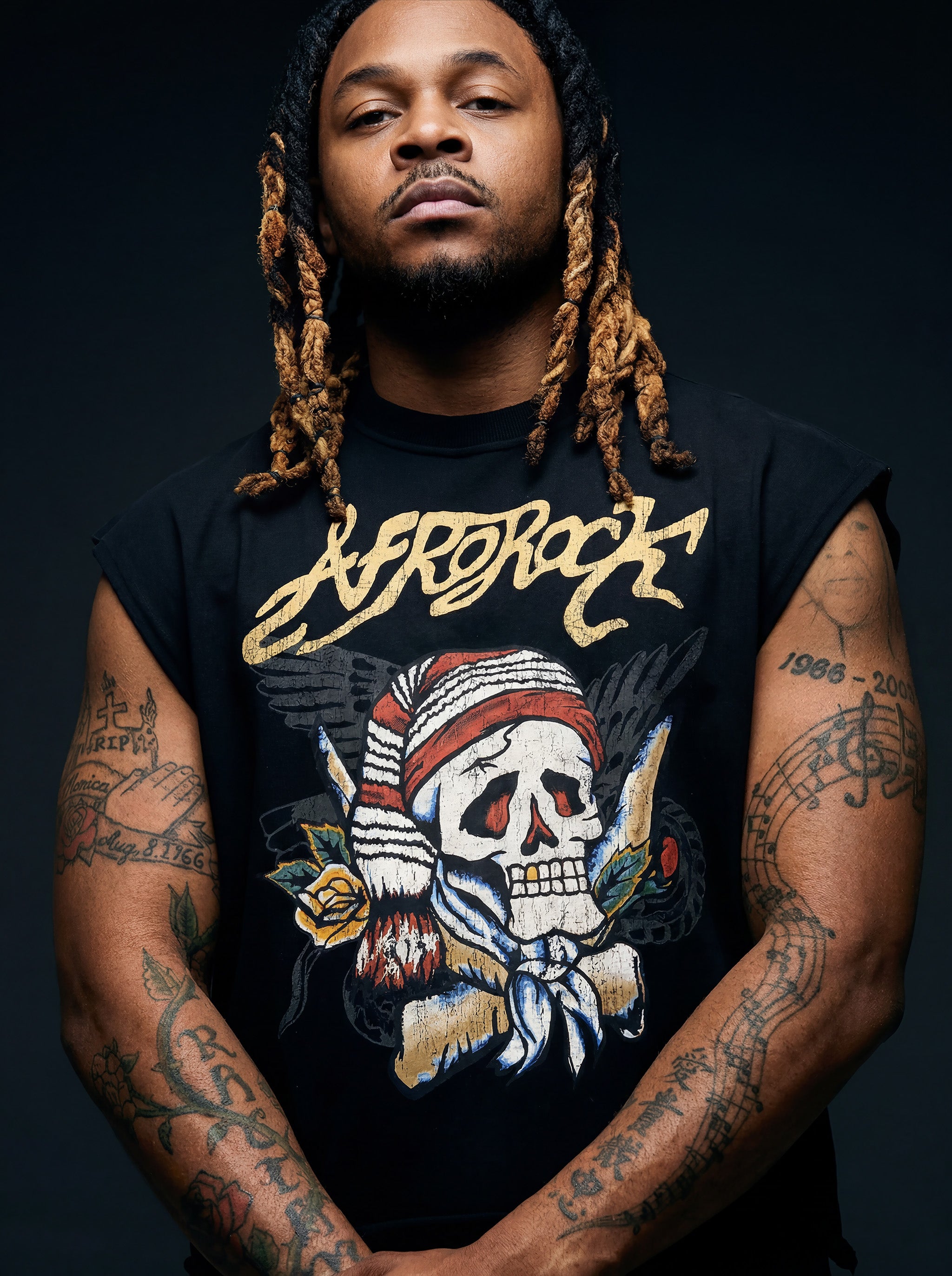 Kal AfroRock wearing the signature Mazi Skull Horns Boxy Tank. This premium streetwear piece features original hand-drawn artwork with a unique crackle effect and bold AfroRock branding.⁠
