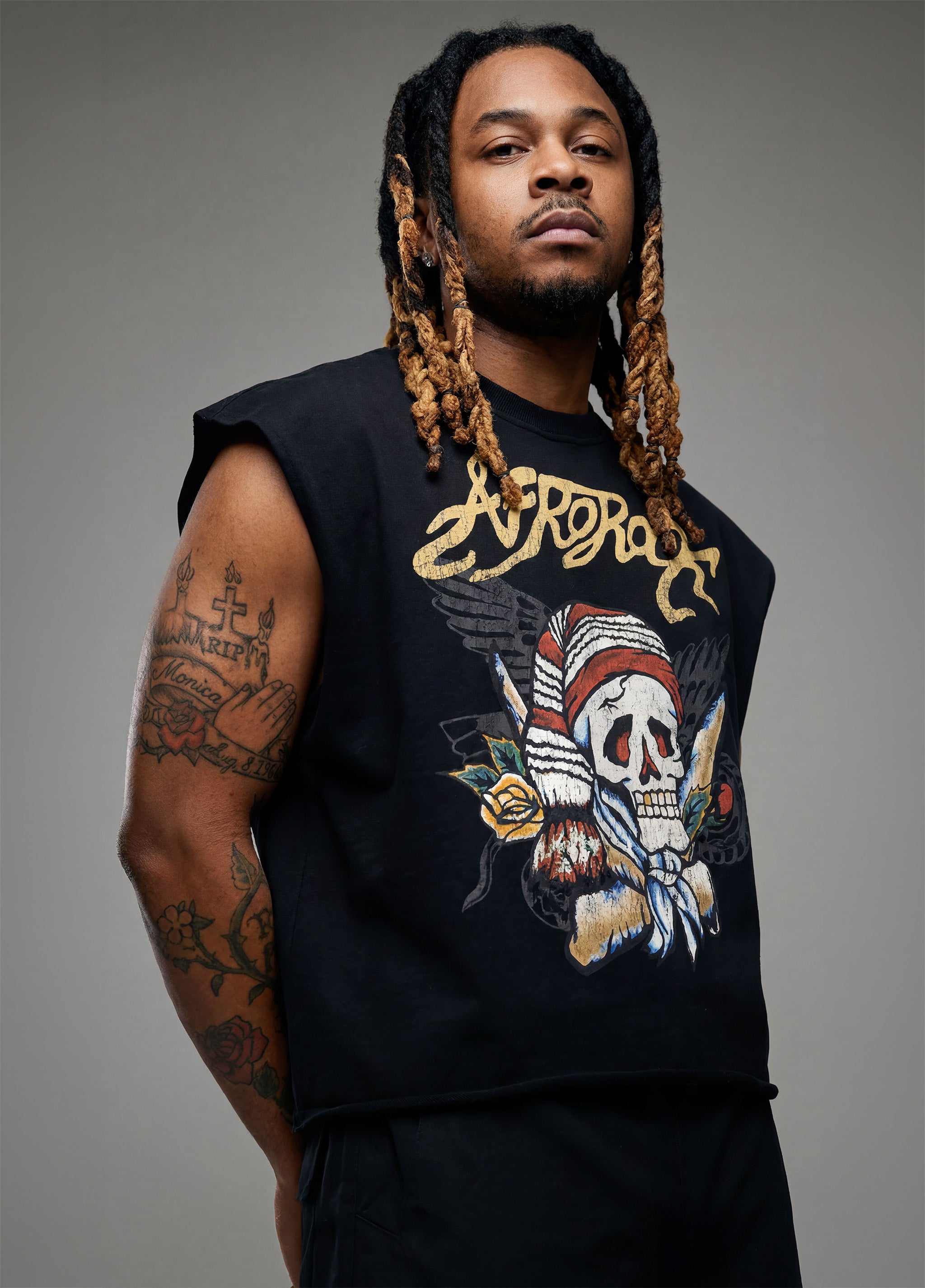 Rear view of Kal AfroRock wearing the signature Mazi Skull Horns Boxy Tank. This premium streetwear piece features original hand-drawn artwork with a unique crackle effect and bold AfroRock branding.⁠