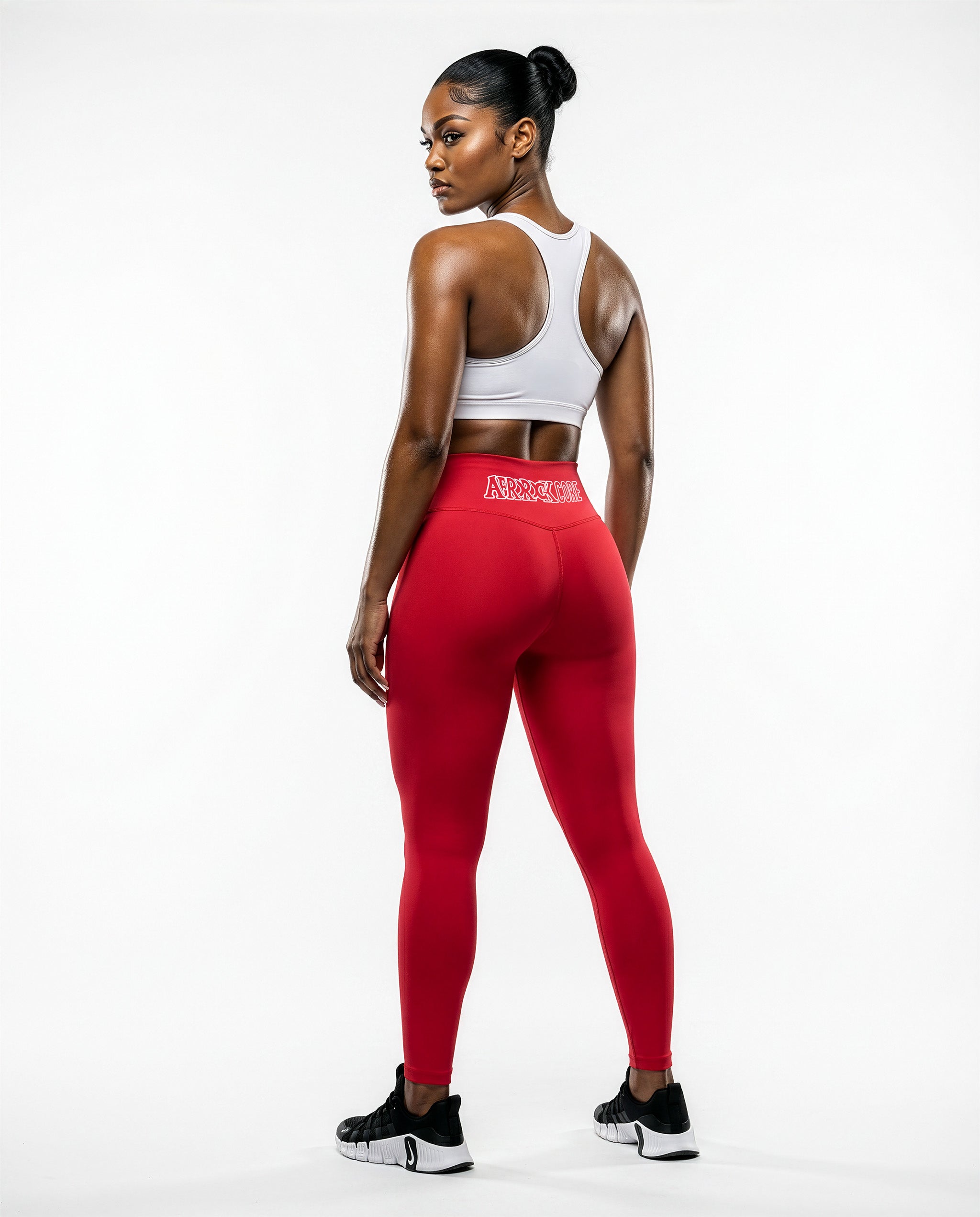 Full Rear view of the AfroRock Core red yoga leggings and sports bra on model Nina, showcasing the premium athletic fit and back branding details.⁠ 