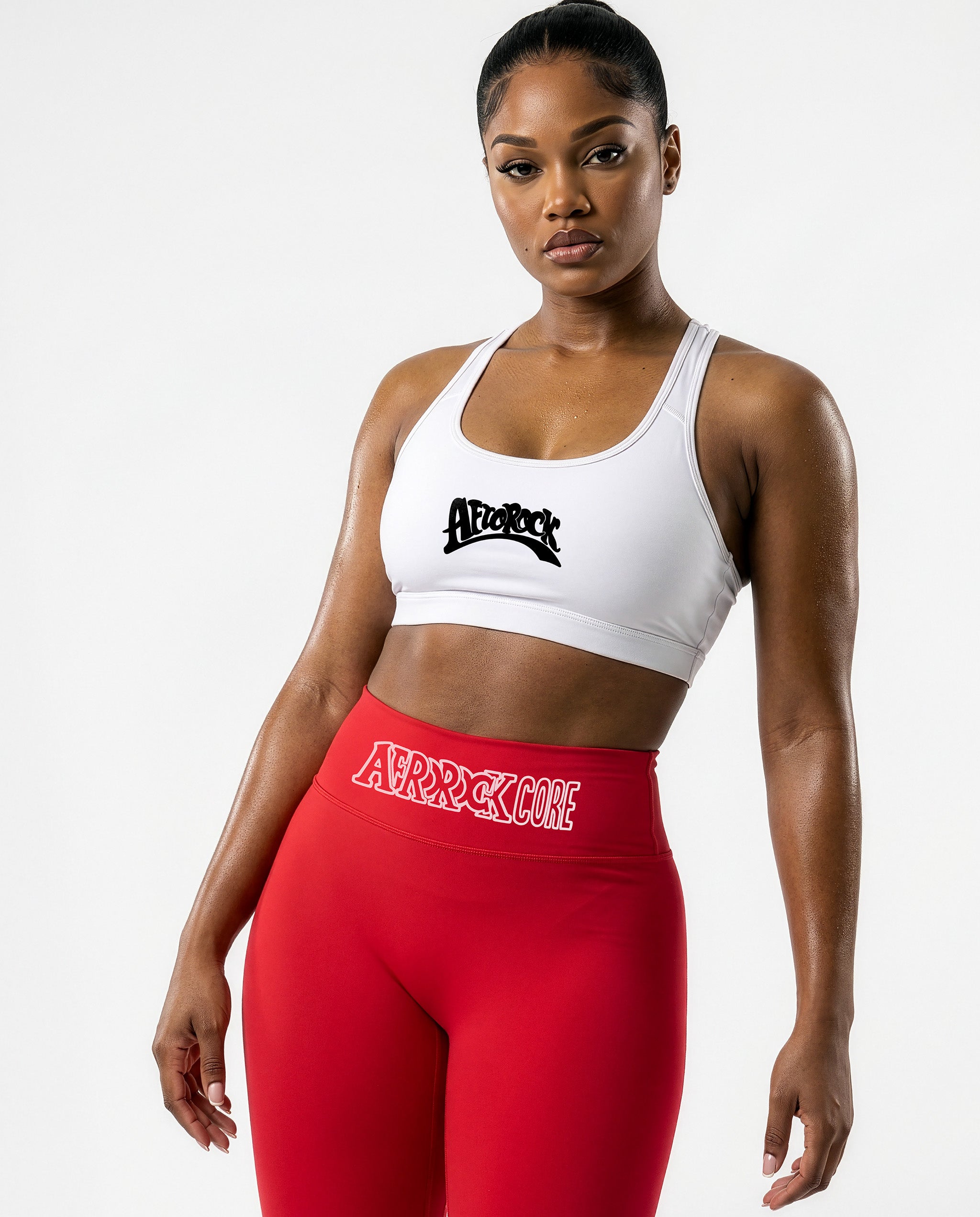 Model Nina wearing the AfroRock Core high-waisted red yoga leggings and white sports bra. Premium streetwear-inspired activewear designed for performance and style.⁠