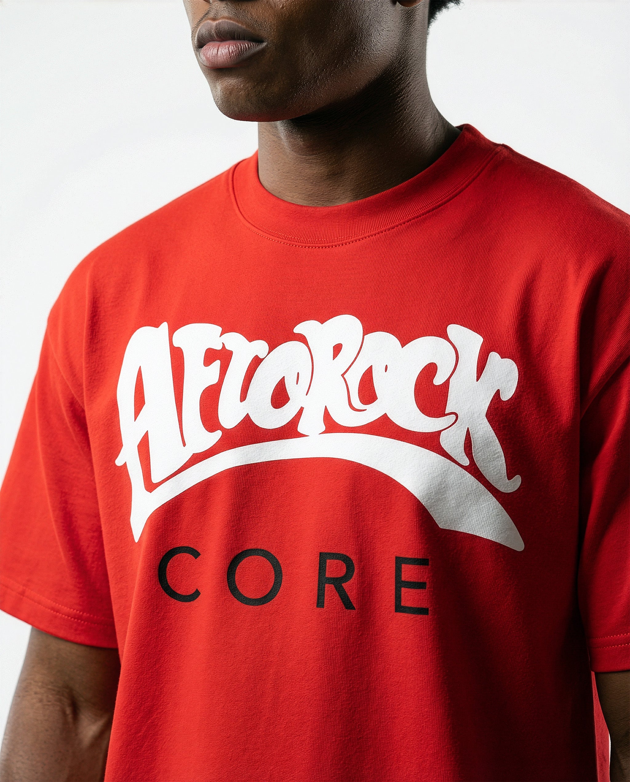 Model Terrell in the AfroRock Core Sorona Quick-Dry Cooling T-Shirt in Crimson Red. Sustainable midweight streetwear graphic tee featuring advanced plant-based eco-fiber technology and bold chest branding by AfroRock.
