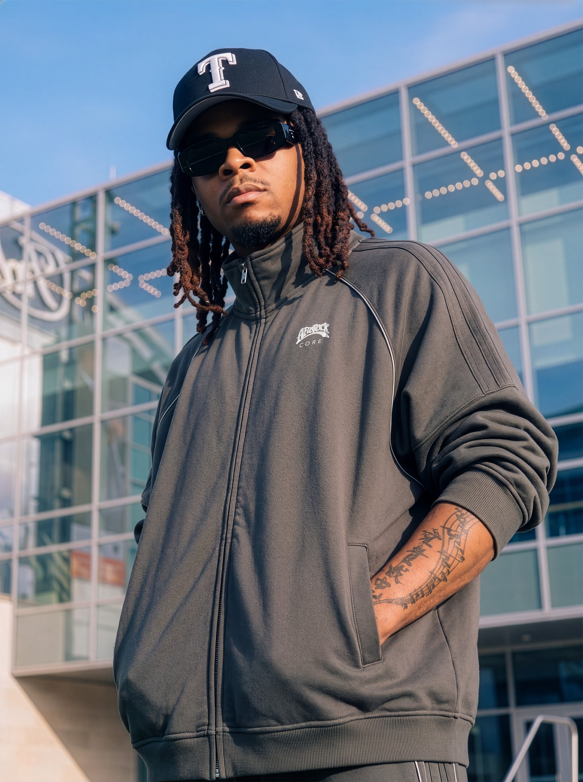 Three-Quarter Side view of the AfroRock Core Reflective Striped Jacket Gray on Kal Afrorock, showcasing the premium streetwear fit and branding details.⁠ 