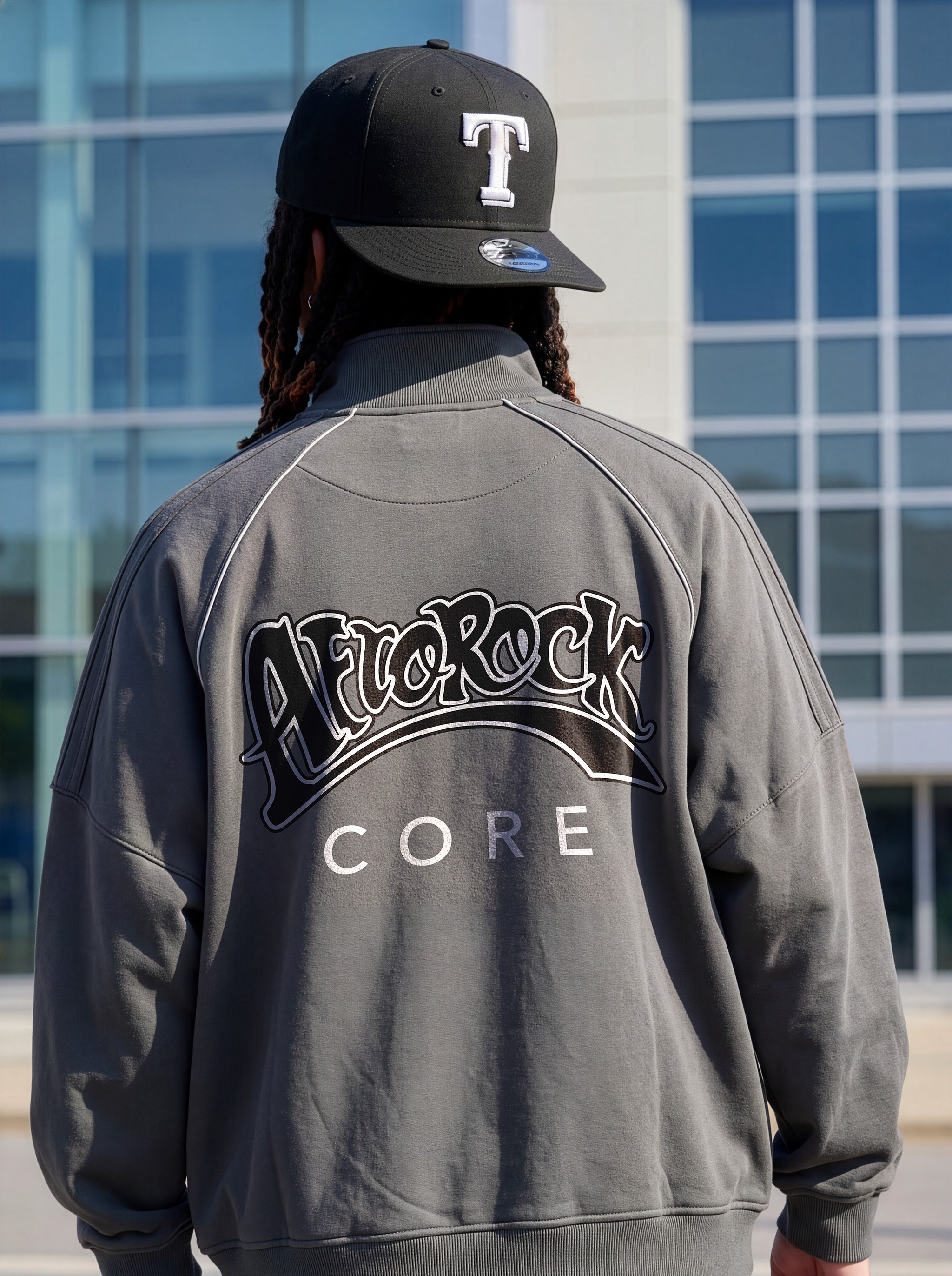 Rear view of the AfroRock Core Reflective Striped Jacket gray on Kal Afrorock, showcasing the premium streetwear fit and branding details.⁠ 
