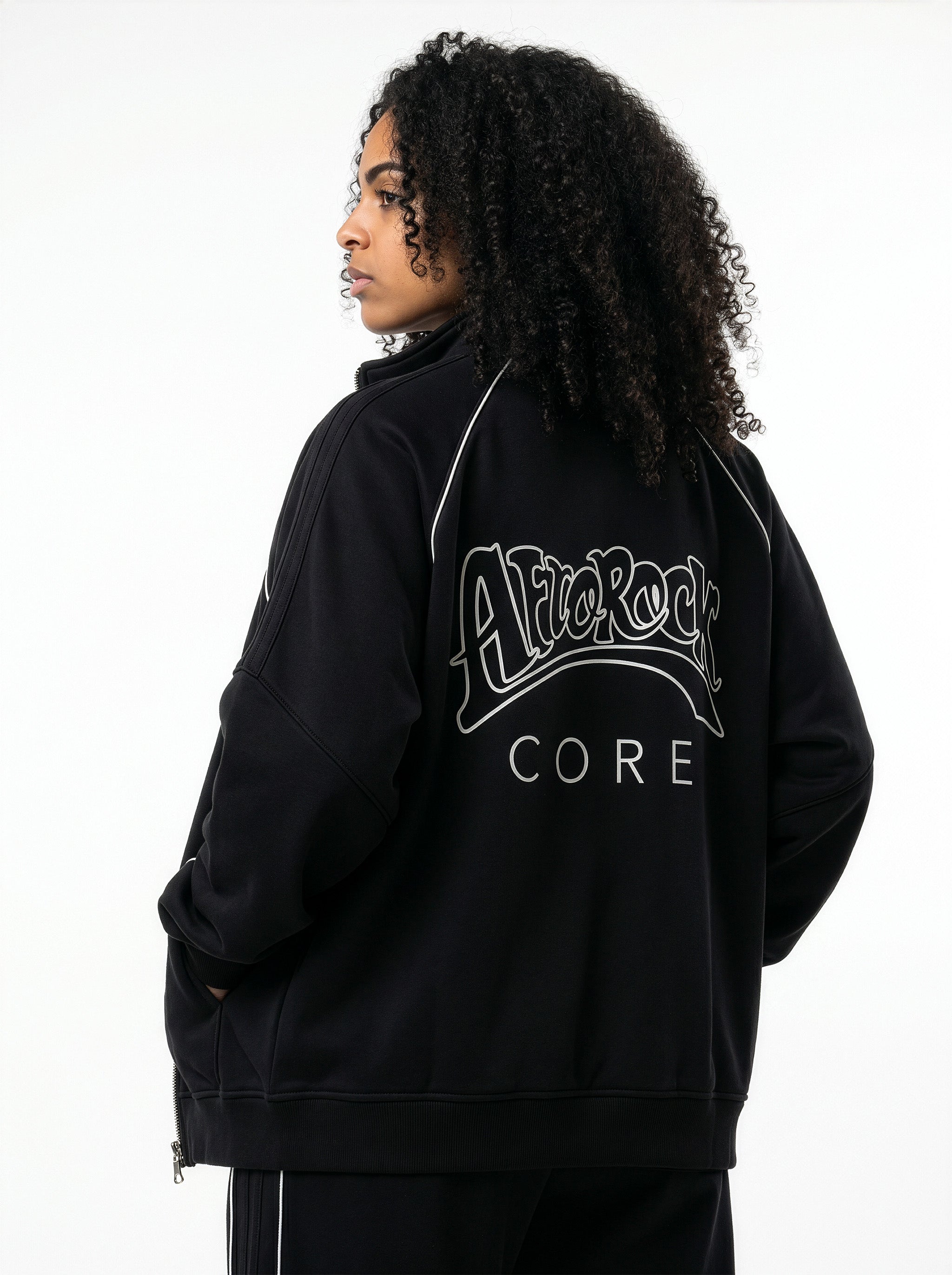 Rear view of the AfroRock Core Reflective Striped Jacket black Set on model Kayla, showcasing the premium streetwear fit and branding details.⁠ 