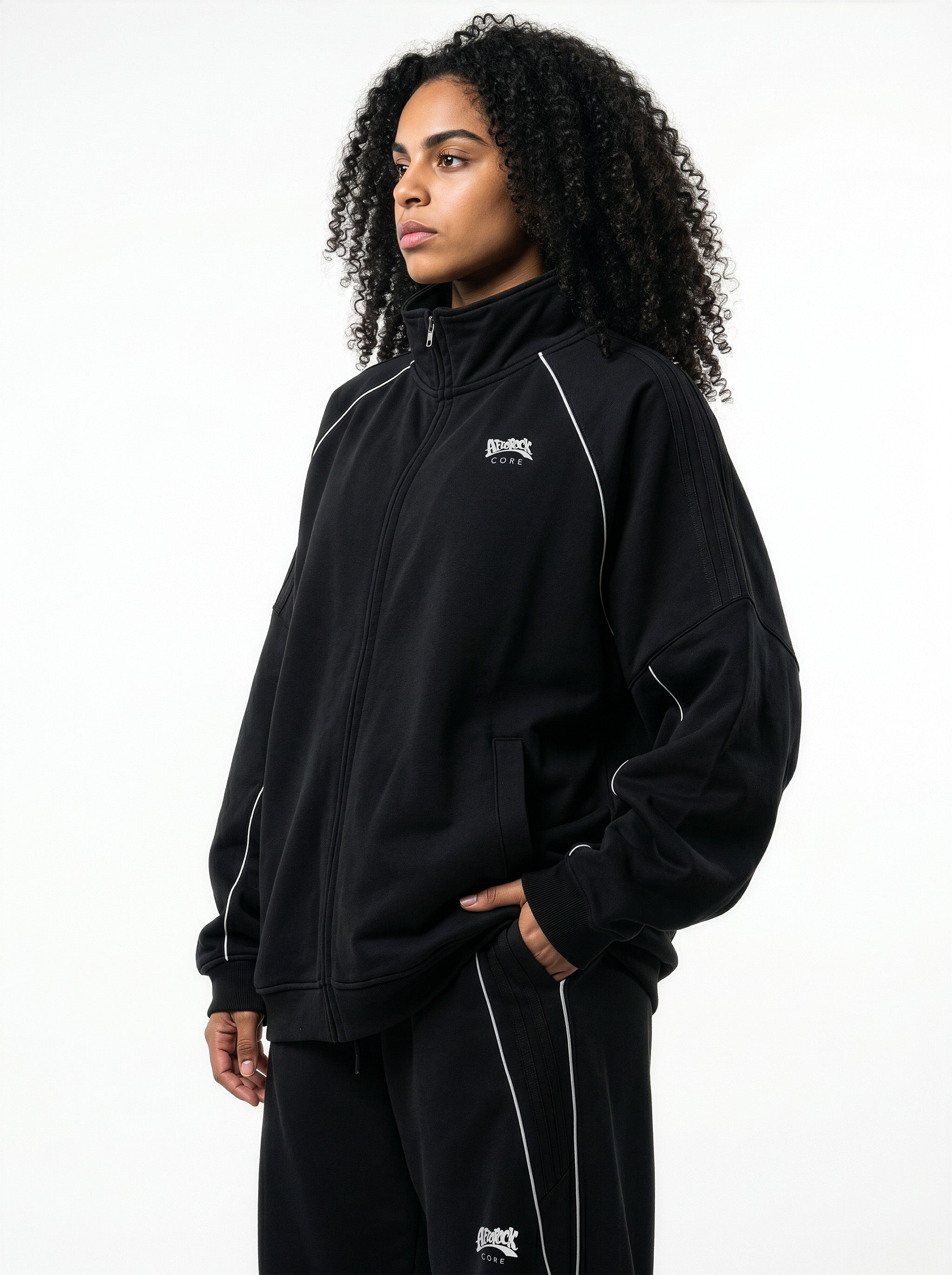 Side view of the AfroRock Core Reflective Striped Jacket black Set and White Sports Bra on model Kayla, showcasing the premium streetwear fit and branding details.⁠ 