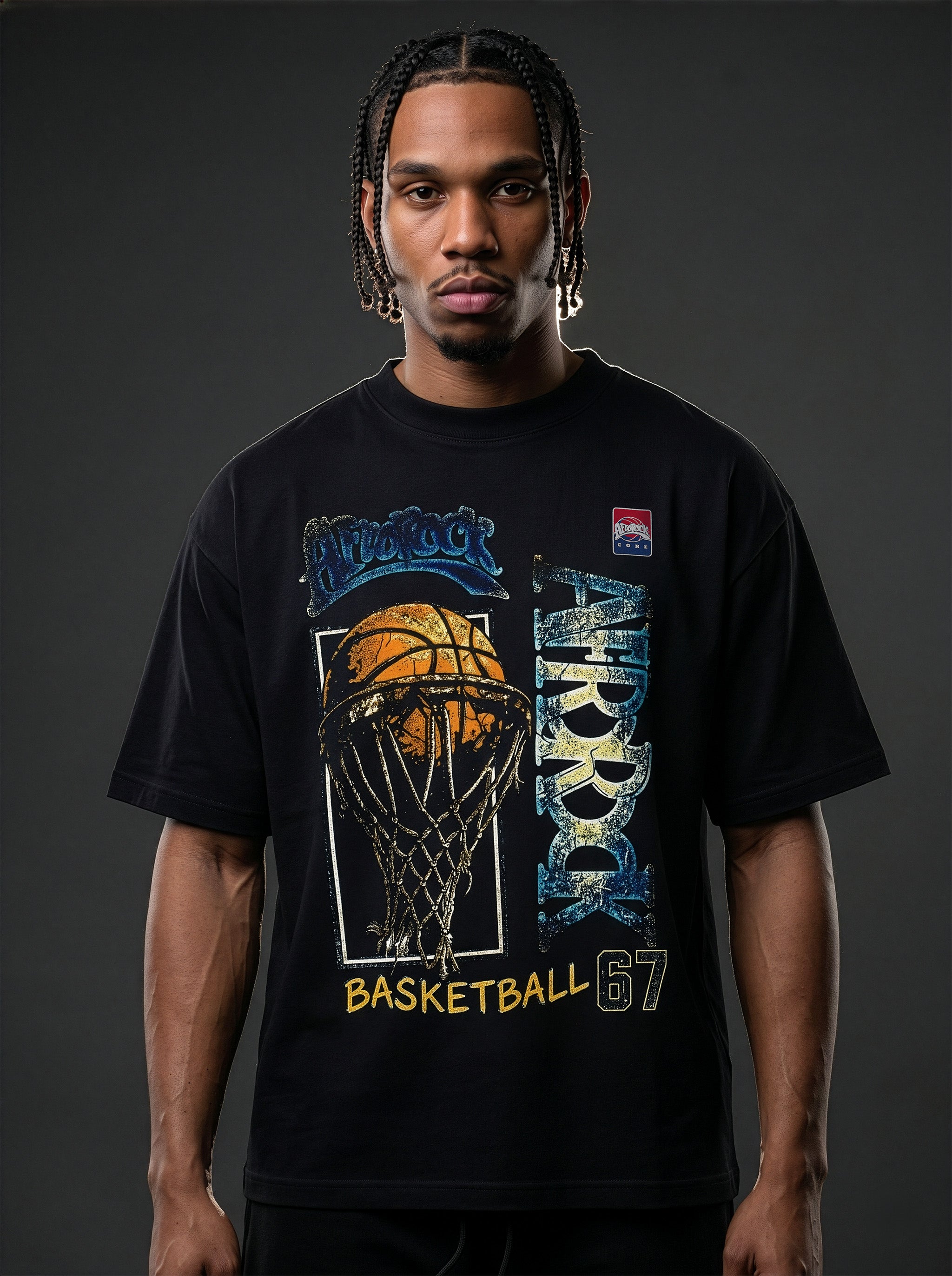 Studio product photography of model Jason in the AfroRock Core streetwear collection. He wears the AfroRock Basketball Vintage Graphic Tee in Pitch Black, an oversized 260gsm cotton shirt with an expansive front graphic of a basketball and hoop, a vintage weather-crackle print finish, and an athletic team badge. Industrial studio lighting highlights a premium sport-heritage lifestyle aesthetic.