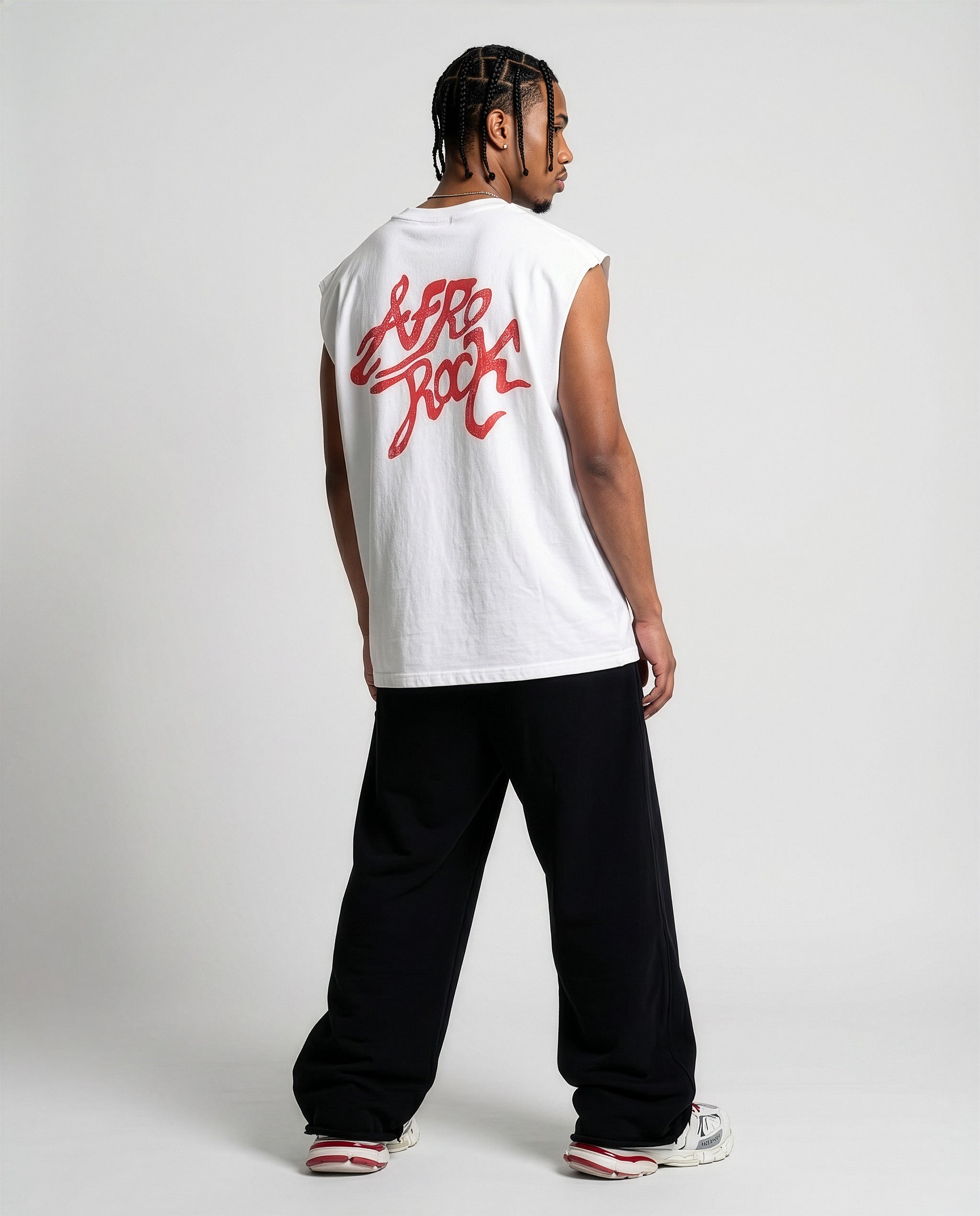 Full Back detail of the AfroRock Ishiagu Raw Edge Flower Gray Tank and Black Baggy Pants on model Jason. This premium streetwear piece features original hand-drawn artwork with a unique crackle effect and bold AfroRock branding.⁠