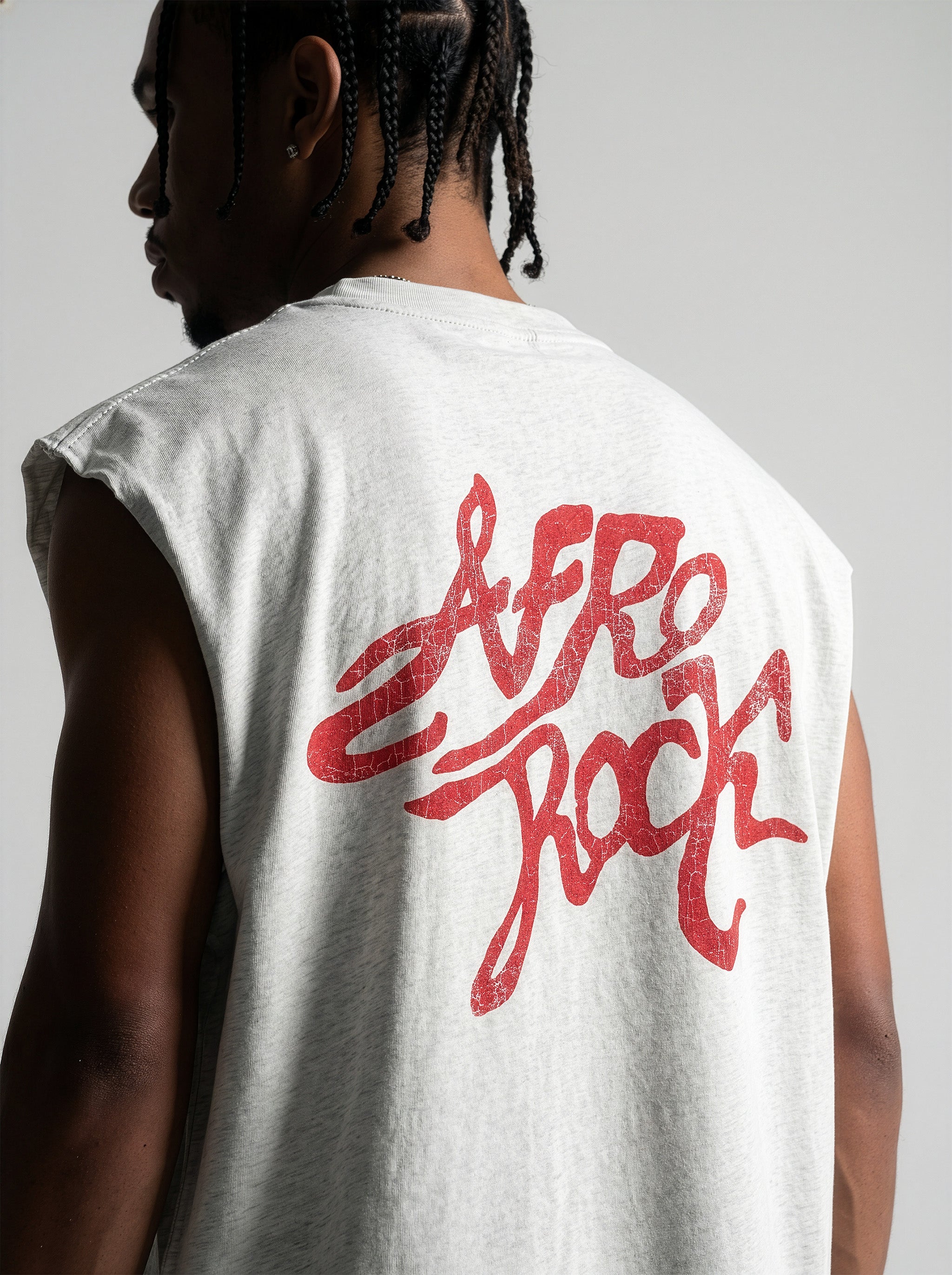 Back view detail of the AfroRock Ishiagu Raw Edge Flower Gray Tank on model Jason. This premium streetwear piece features original hand-drawn artwork with a unique crackle effect and bold AfroRock branding.⁠