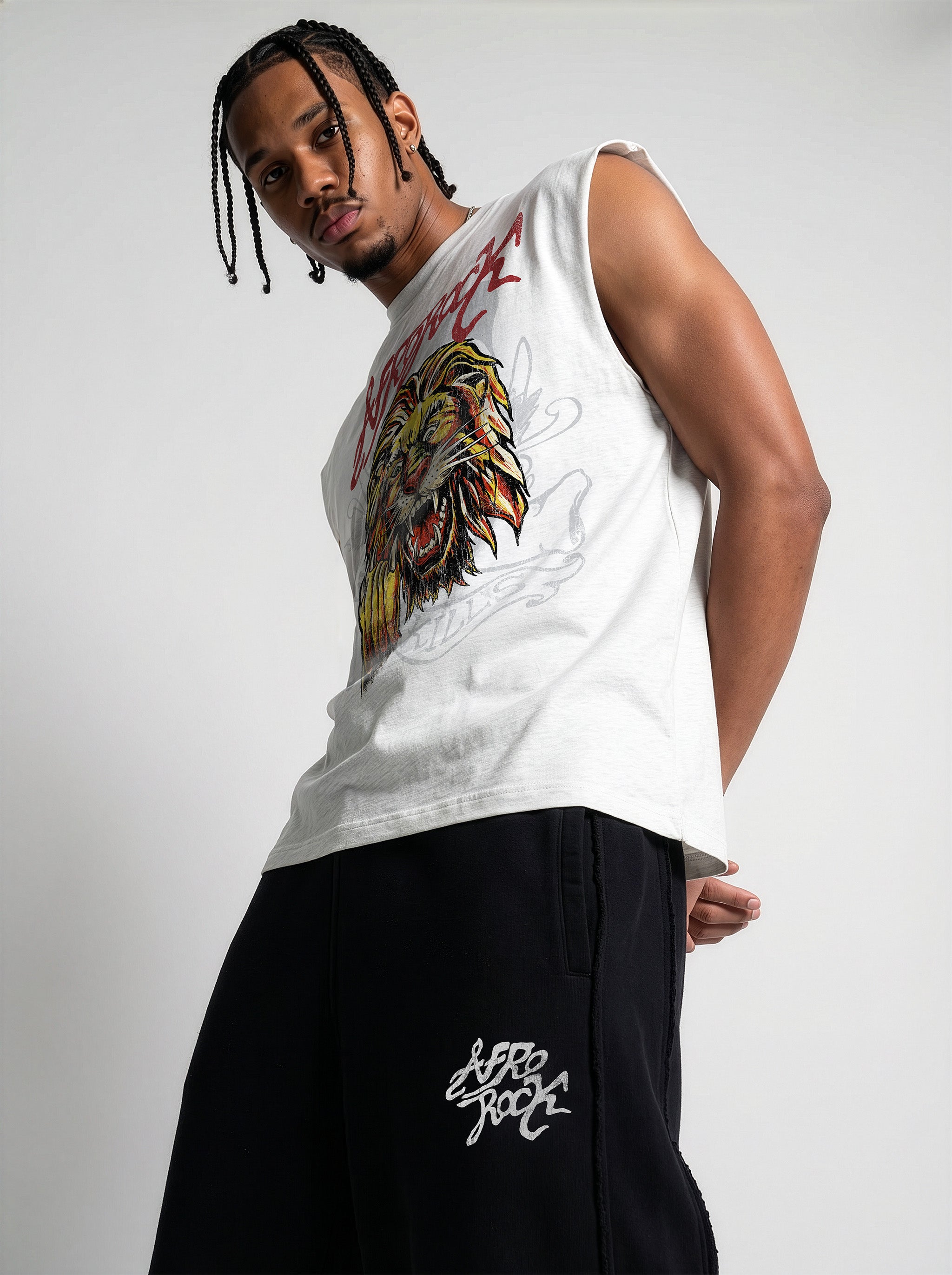 Side View of the AfroRock Ishiagu Raw Edge Flower Gray Tank and Black Baggy Pants on model Jason. This premium streetwear piece features original hand-drawn artwork with a unique crackle effect and bold AfroRock branding.⁠