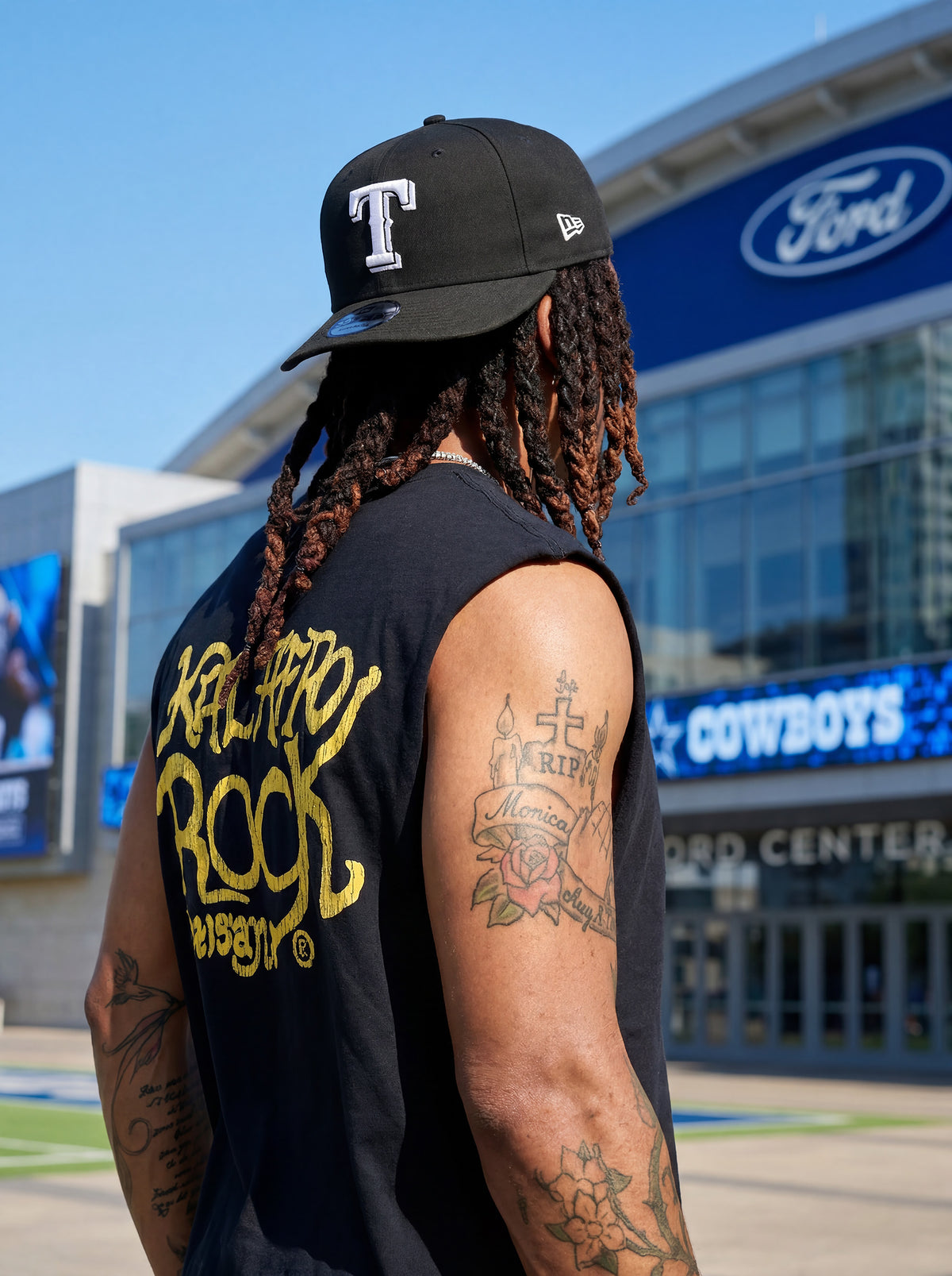 Back Detail of Kal AfroRock wearing the signature Longhorn Texas Raw Edge Tank Black. This premium streetwear piece features original hand-drawn artwork with a unique crackle effect and bold AfroRock branding.⁠