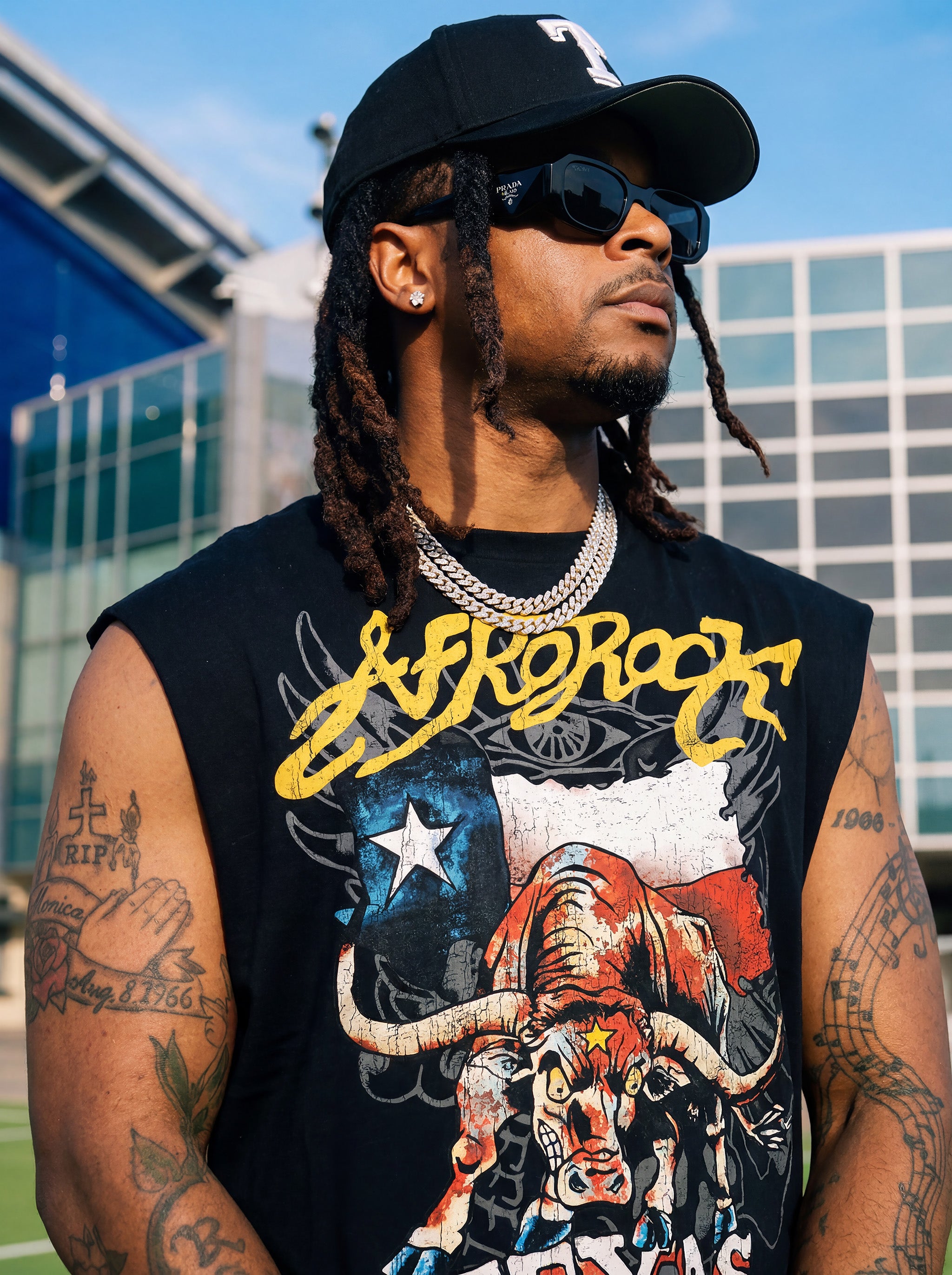 Front Side view of Kal AfroRock wearing the signature Longhorn Texas Raw Edge Tank Black. This premium streetwear piece features original hand-drawn artwork with a unique crackle effect and bold AfroRock branding.⁠