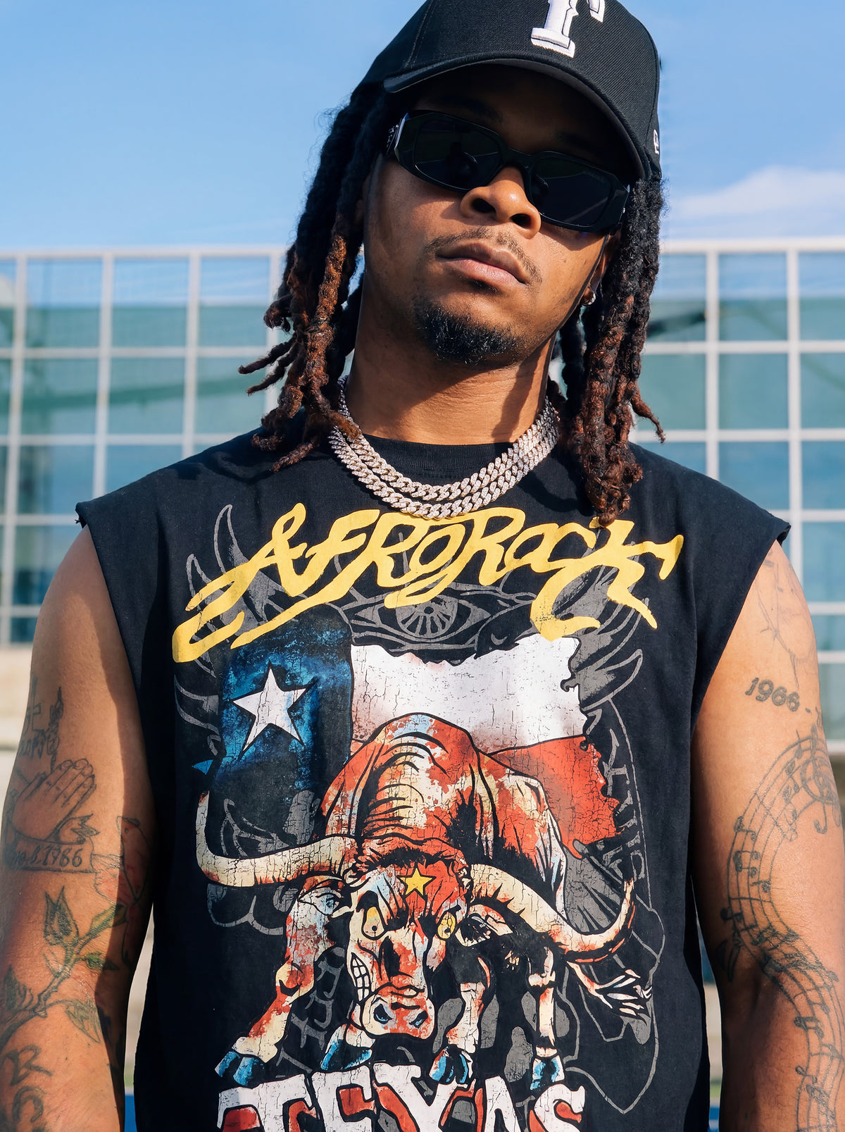 Front view of Kal AfroRock wearing the signature Longhorn Texas Raw Edge Tank Black. This premium streetwear piece features original hand-drawn artwork with a unique crackle effect and bold AfroRock branding.⁠