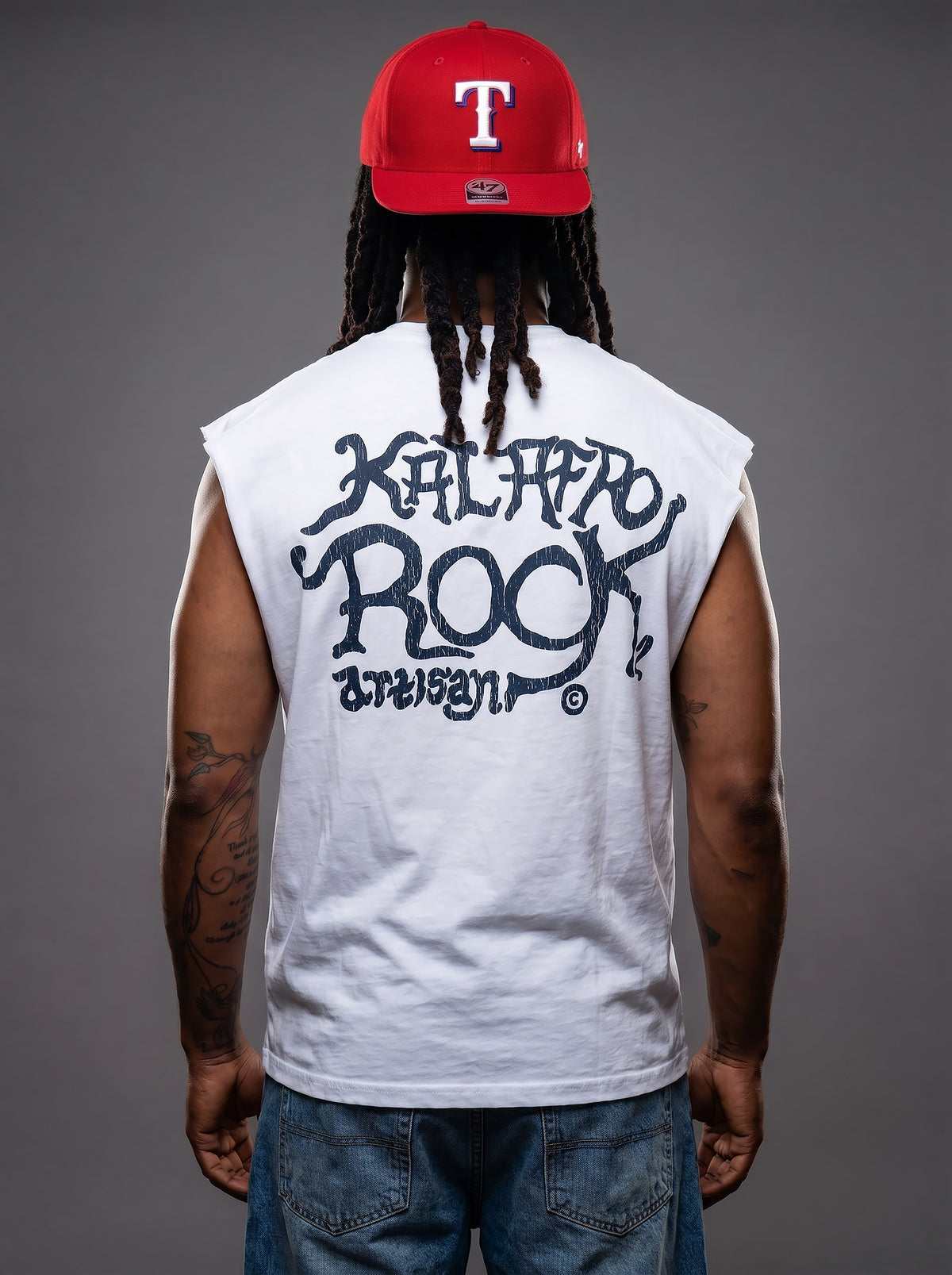 Rear view of Kal AfroRock wearing the signature Longhorn Texas Raw Edge Tank. This premium streetwear piece features original hand-drawn artwork with a unique crackle effect and bold AfroRock branding.⁠