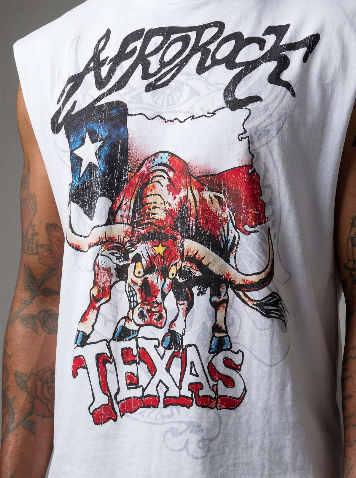 Front Detail view of Kal AfroRock wearing the signature Longhorn Texas Raw Edge Tank. This premium streetwear piece features original hand-drawn artwork with a unique crackle effect and bold AfroRock branding.⁠