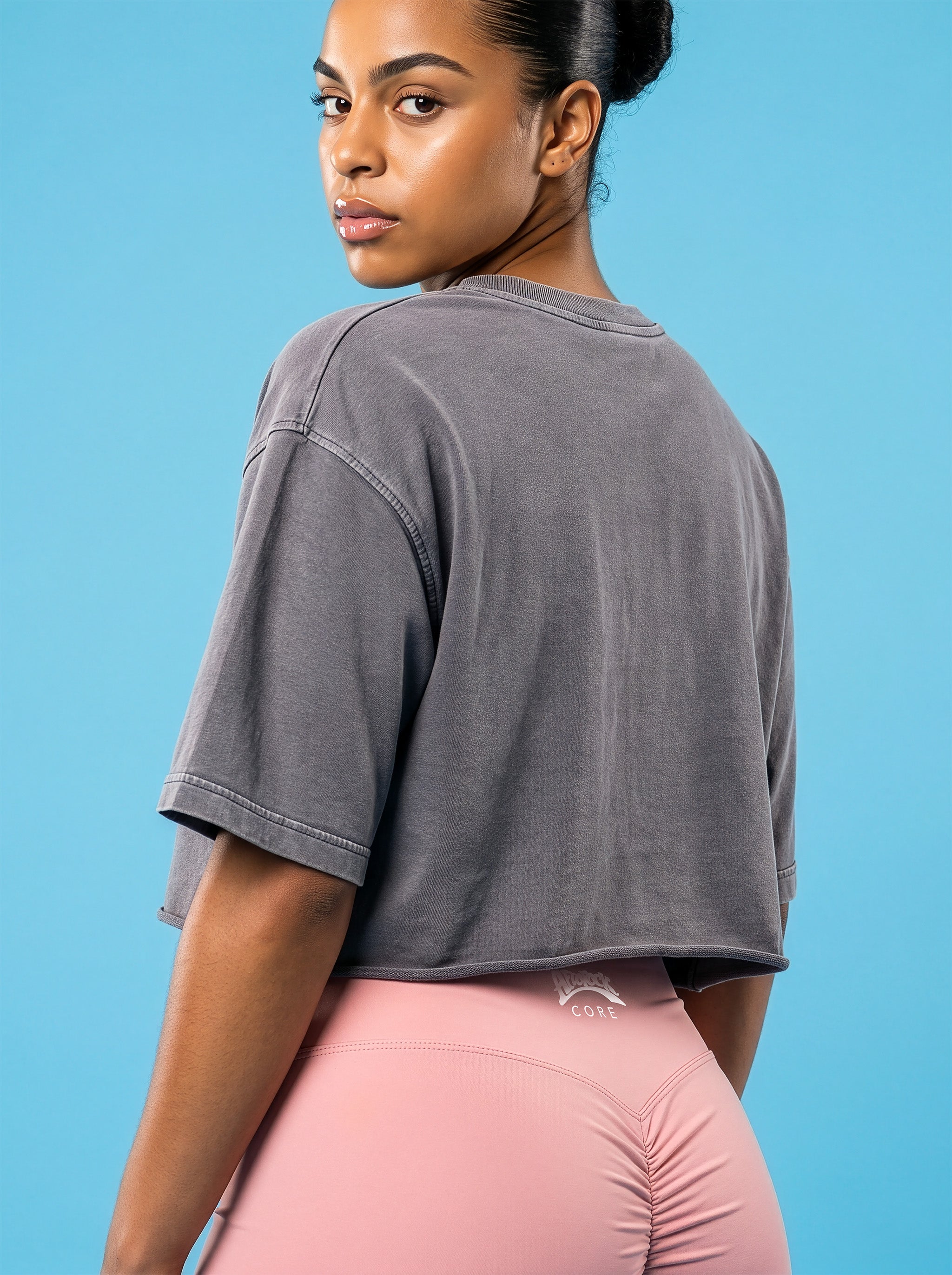Rear view of the AfroRock Ishiagu Washed Raw Edge Gary Crop Top and Pink High-Waisted Biker Shorts on model Kayla, showcasing the premium streetwear fit and branding details.⁠ 