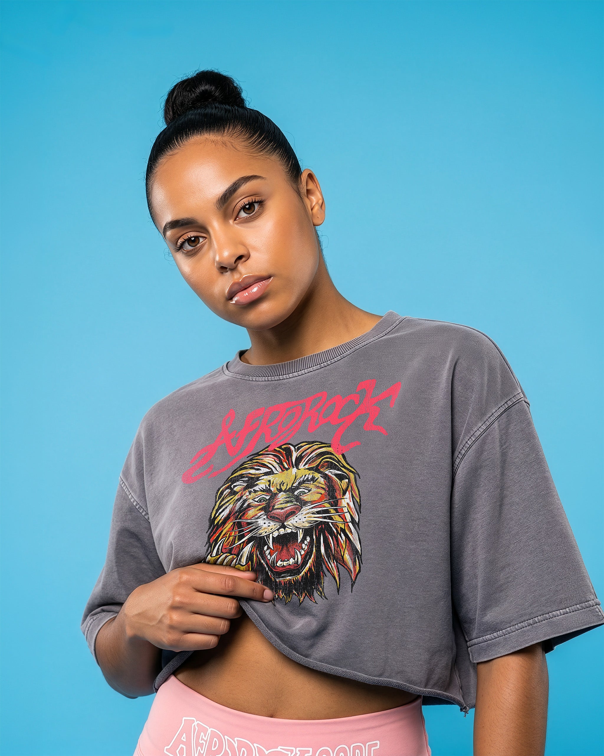 Front view of the AfroRock Ishiagu Washed Raw Edge Gary Crop Top and Pink High-Waisted Biker Shorts on model Kayla, showcasing the premium streetwear fit and branding details.⁠ 