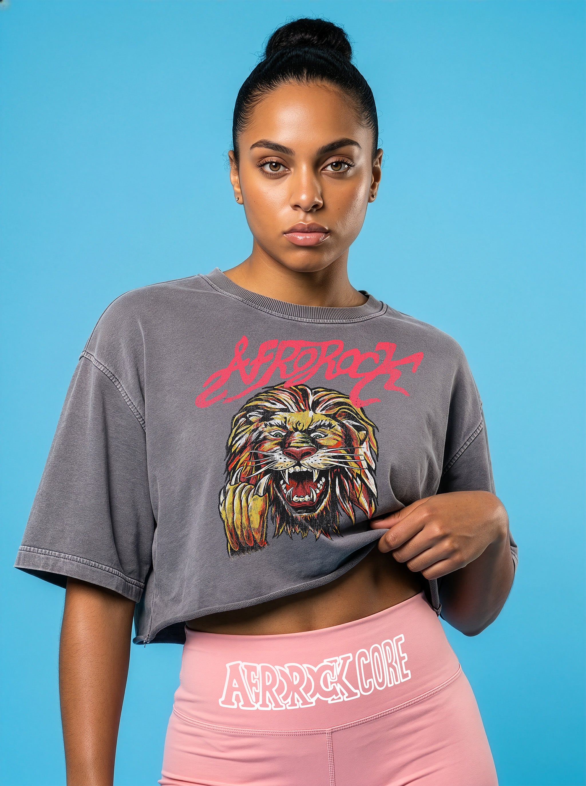 Front view of the AfroRock Ishiagu Washed Raw Edge Gary Crop Top and Pink High-Waisted Biker Shorts on model Kayla, showcasing the premium streetwear fit and branding details.⁠ 