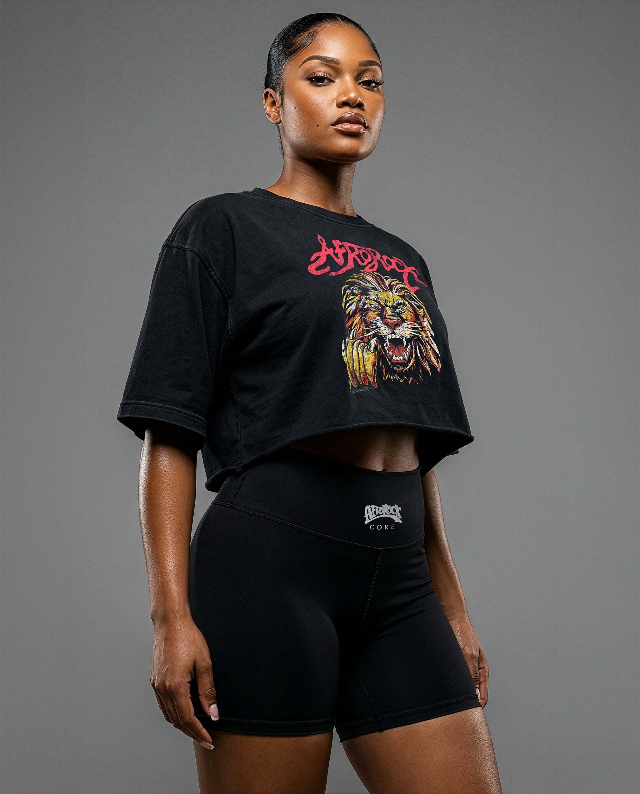 Front Side view of the AfroRock Ishiagu Washed Raw Edge Black Crop Top and High-Waisted Biker Shorts on model Nina, showcasing the premium streetwear fit and branding details.⁠ 