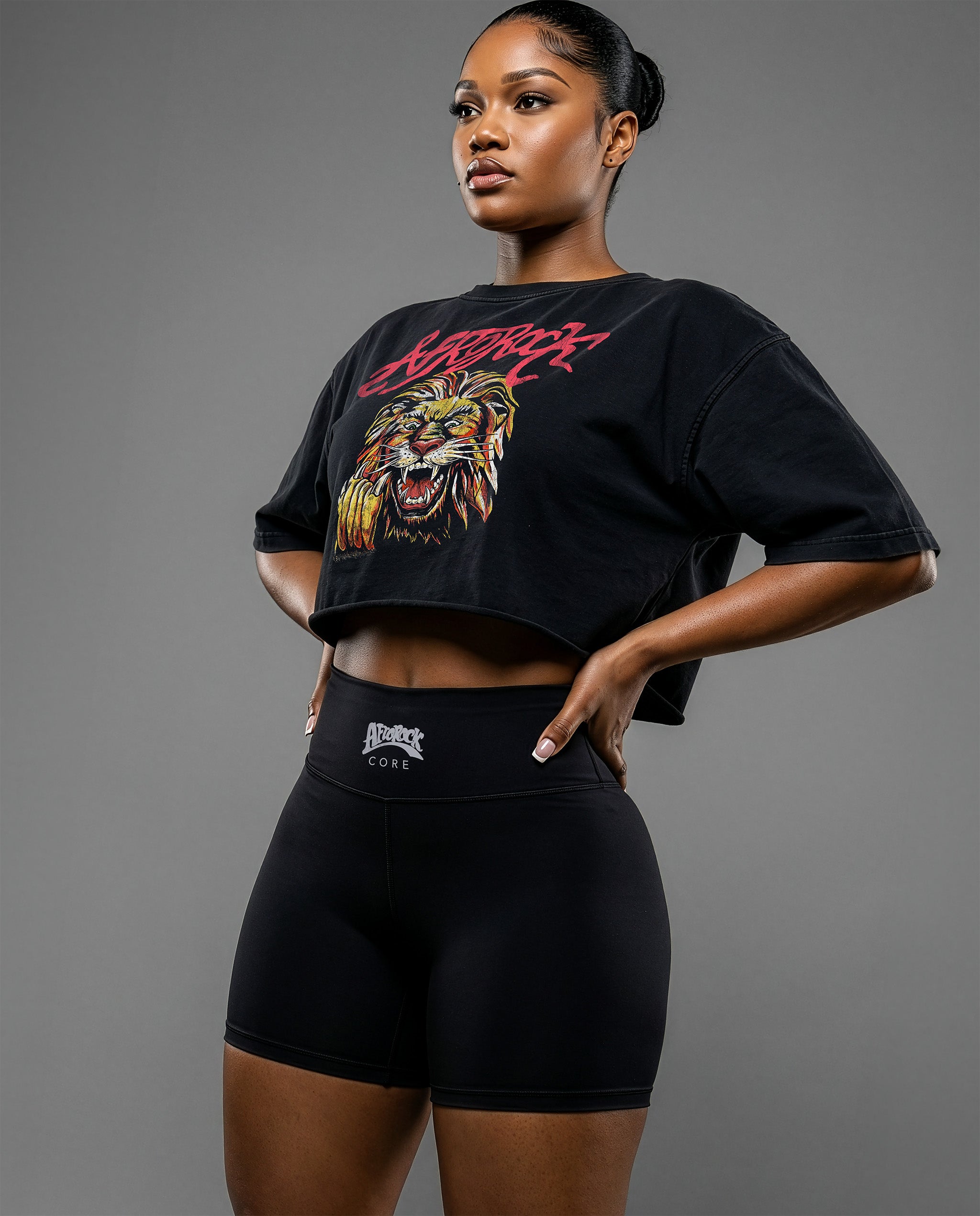 Side view of the AfroRock Ishiagu Washed Raw Edge Black Crop Top and High-Waisted Biker Shorts on model Nina, showcasing the premium streetwear fit and branding details.⁠ 