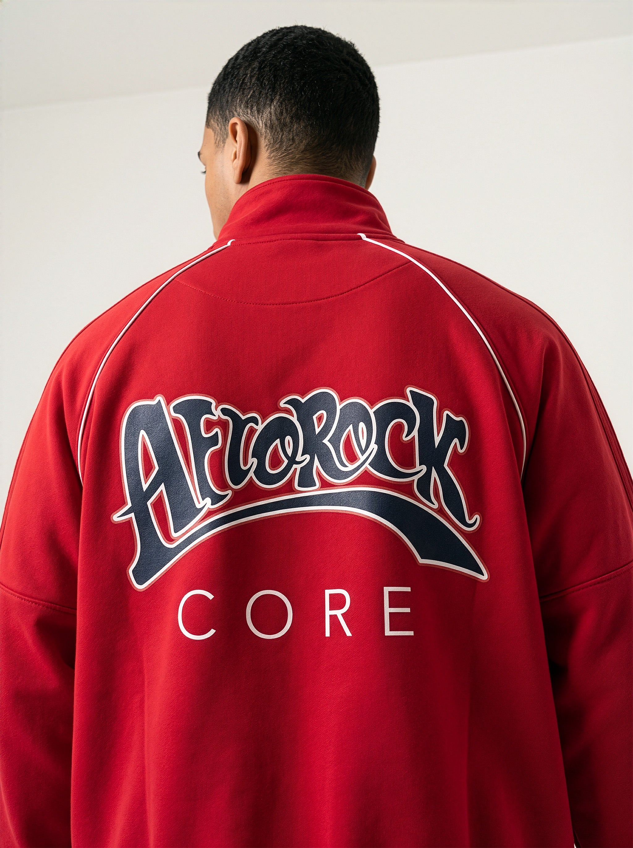 Back view of the AfroRock Core Reflective Striped Jacket Red Set on model Zach, showcasing the premium streetwear fit and branding details.⁠ 