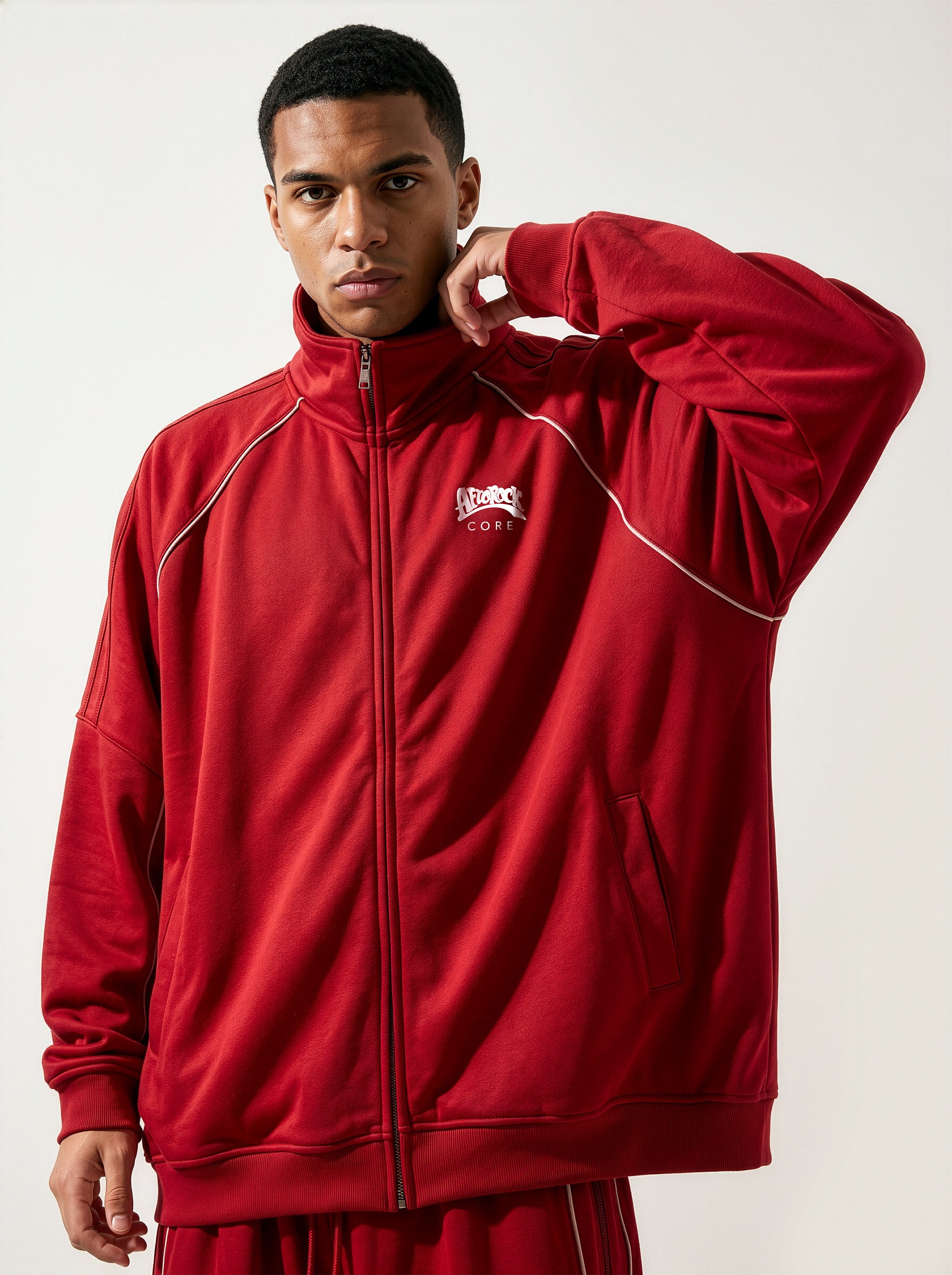 Front detail of the AfroRock Core Reflective Striped Jacket Red Set on model Zach, showcasing the premium streetwear fit and branding details.⁠ 