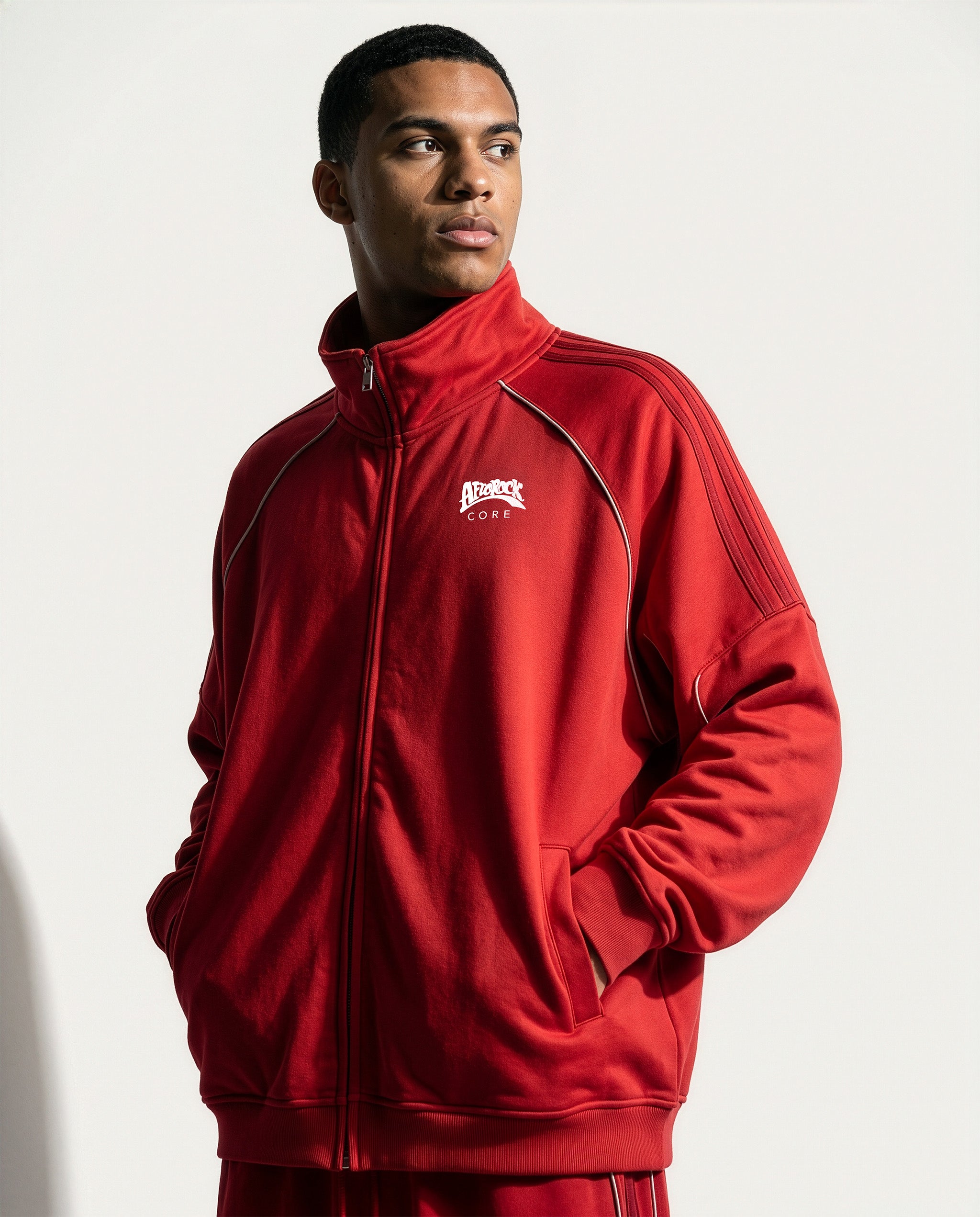 Front view of the AfroRock Core Reflective Striped Jacket Red on model Zach, showcasing the premium streetwear fit and branding details.⁠ 