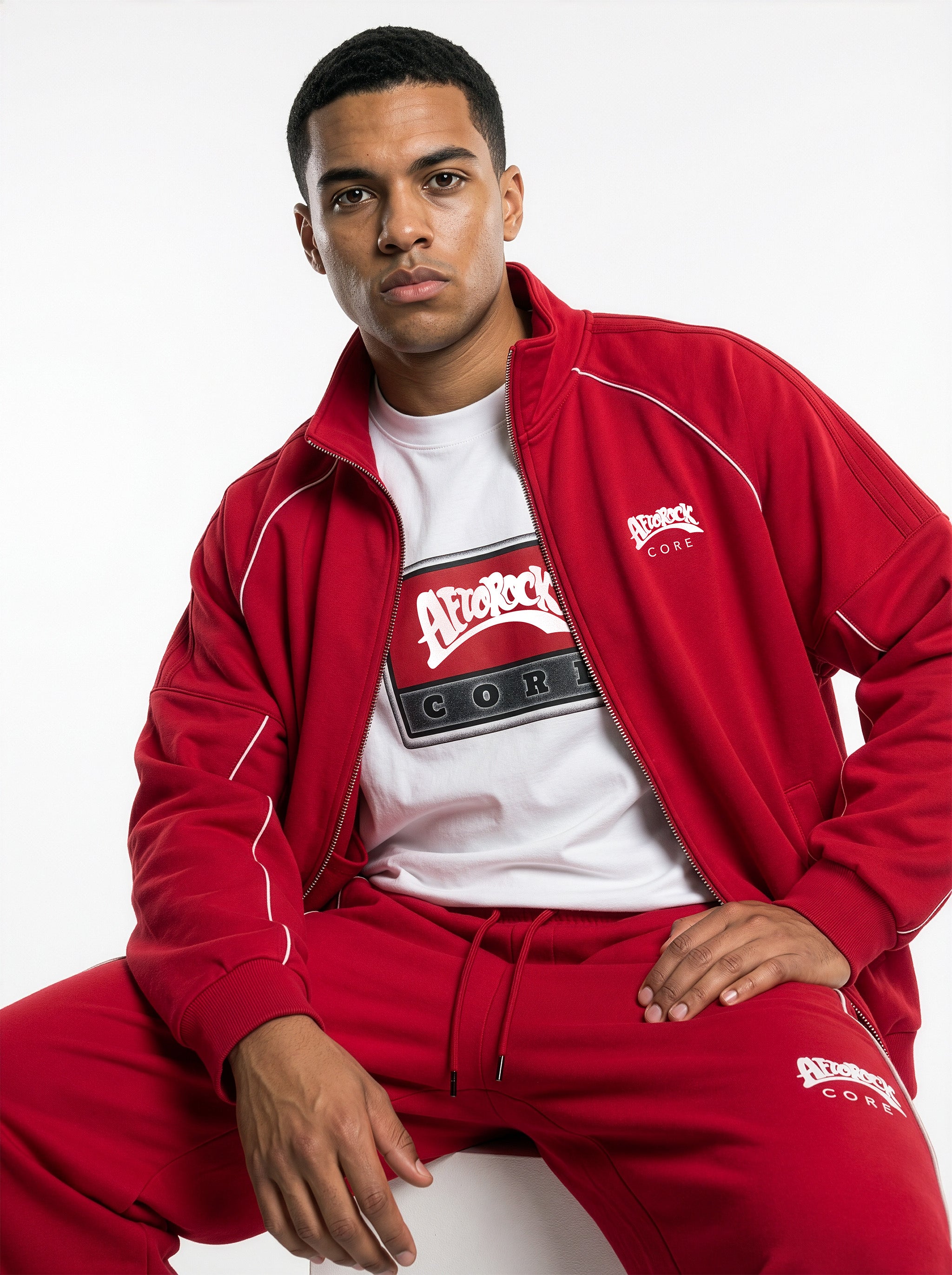 Front detail of the AfroRock Core Reflective Striped Jacket Red Set and AfroRock Core White Tee on model Zach, showcasing the premium streetwear fit and branding details.⁠ 