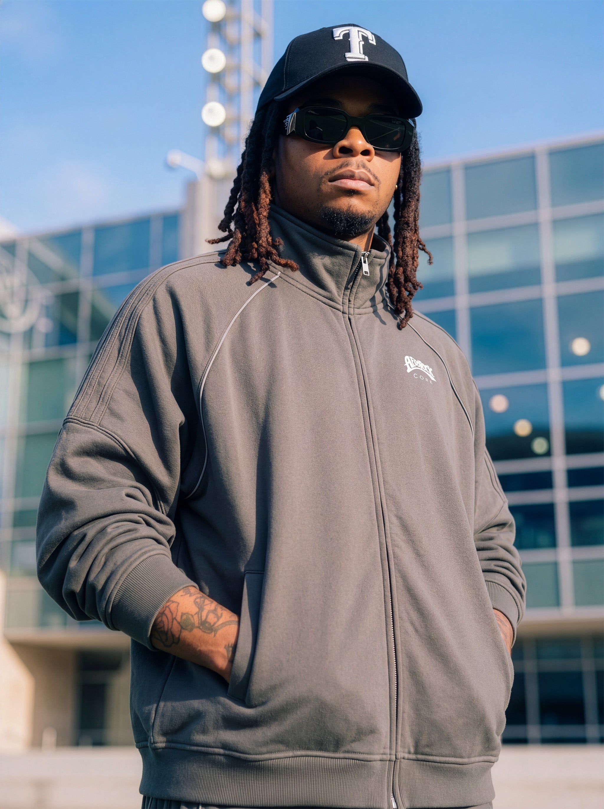 Three-Quarter Side view of the AfroRock Core Reflective Striped Jacket Gray on Kal Afrorock, showcasing the premium streetwear fit and branding details.⁠ 